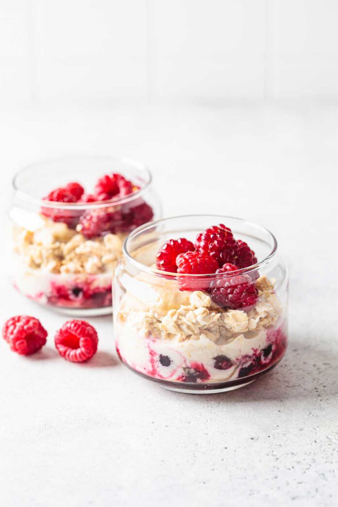 Overnight oatmeal with raspberries, currants and tahini in jar