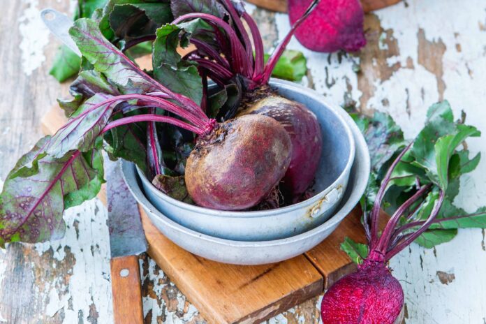 Fresh beets in a bowl on rustic table
