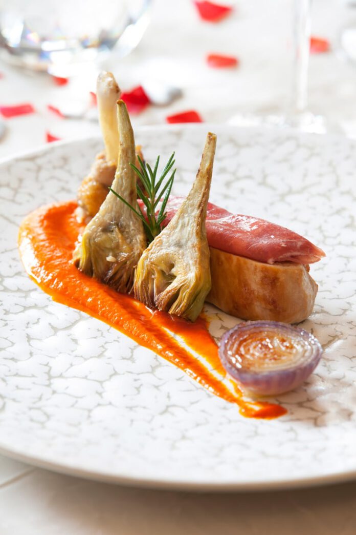 Guinea Fowl Breast cooked at low temperature and wrapped in Ham with Red Tropea Onion, Artichoke Bouquet and Piquillo Purée