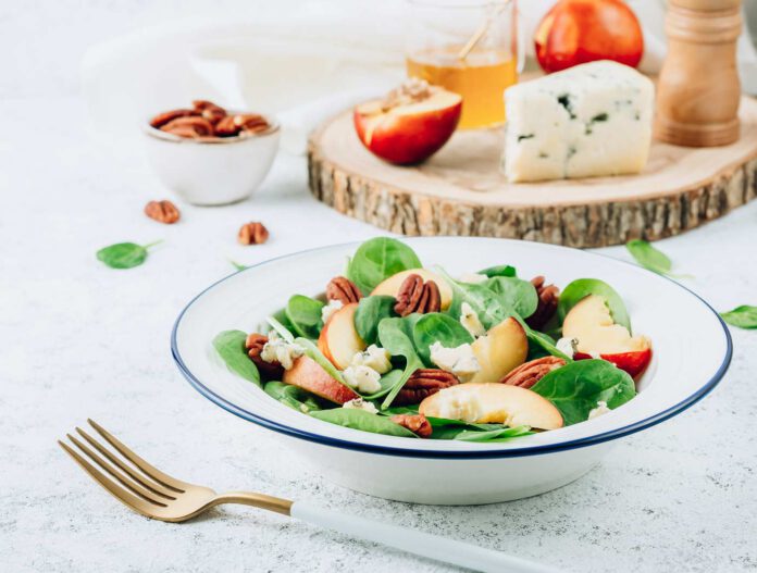 Salad with Spinach, Peach, Pecan Nuts and Blue Cheese