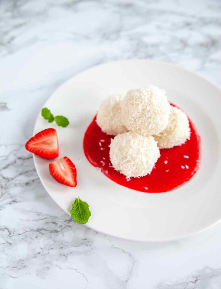 Coconut-coated rice pudding arancini with strawberry sauce