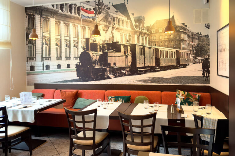 Cozy cafe with vintage train wall mural.