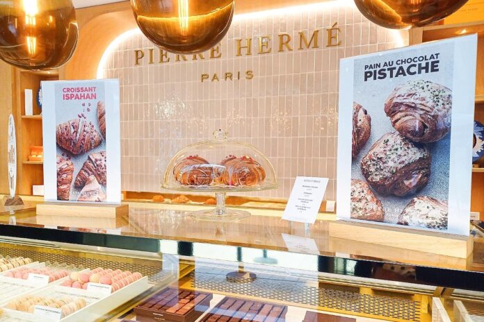 Pierre Hermé pastries display in Paris shop.