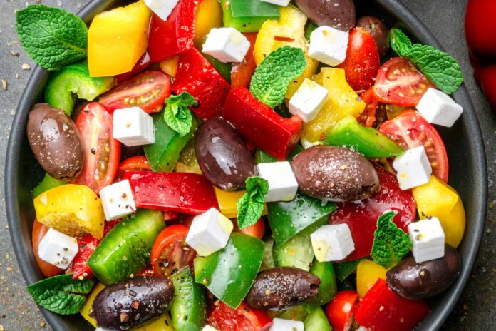 Colorful Greek salad with olives and feta cheese.