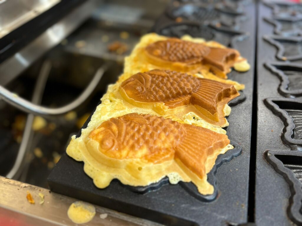 Taiyaki fish-shaped cakes baking on griddle