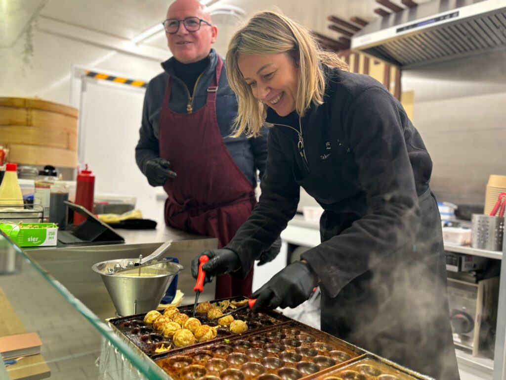 People cooking pastries in a commercial kitchen.