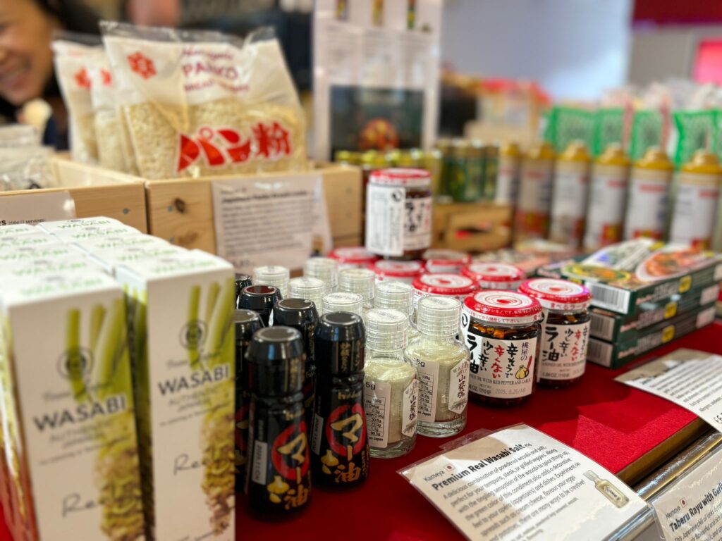 Variety of Japanese condiments displayed on red table.