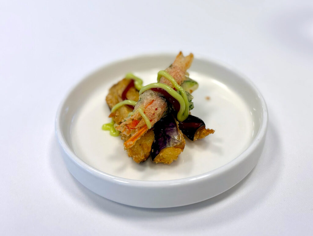 Tempura vegetables with sauce on white plate