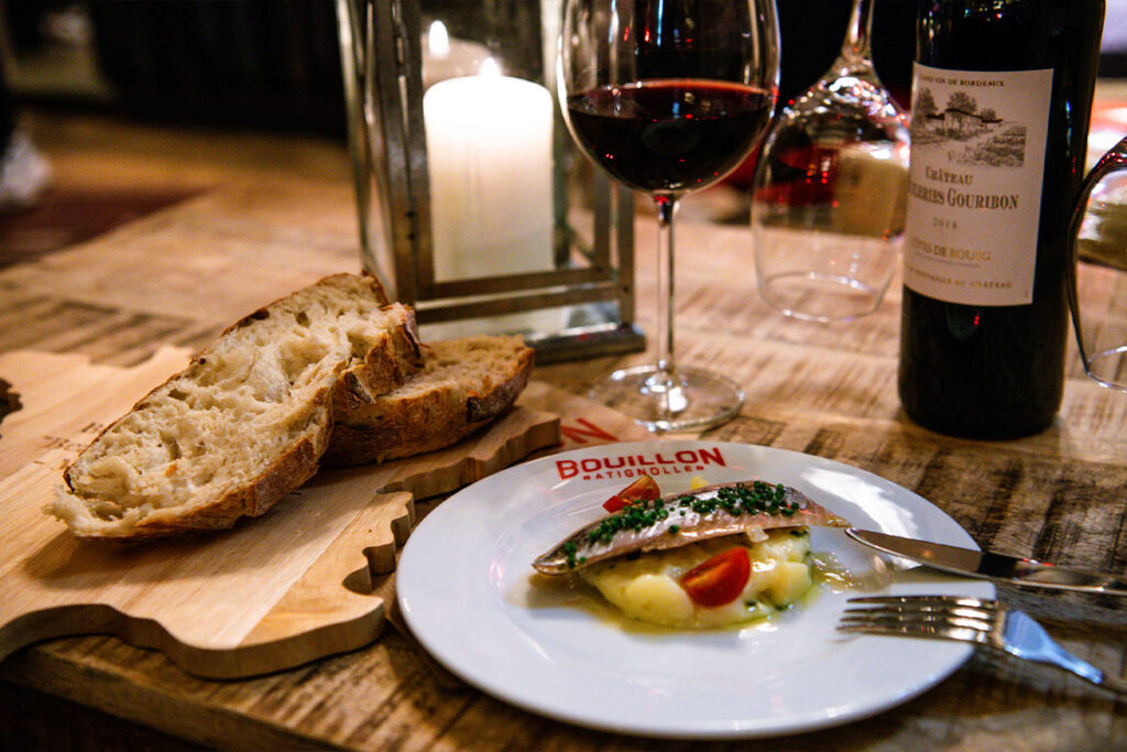 French meal with bread, wine, and candlelight.