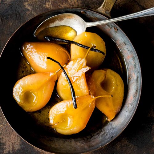 Poached pears with vanilla in a pan
