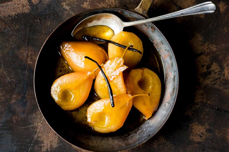 Poached pears with vanilla in a pan