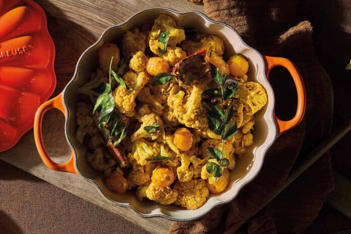 Curry-of-Cauliflower-&-Coconut Curried cauliflower in orange casserole dish.