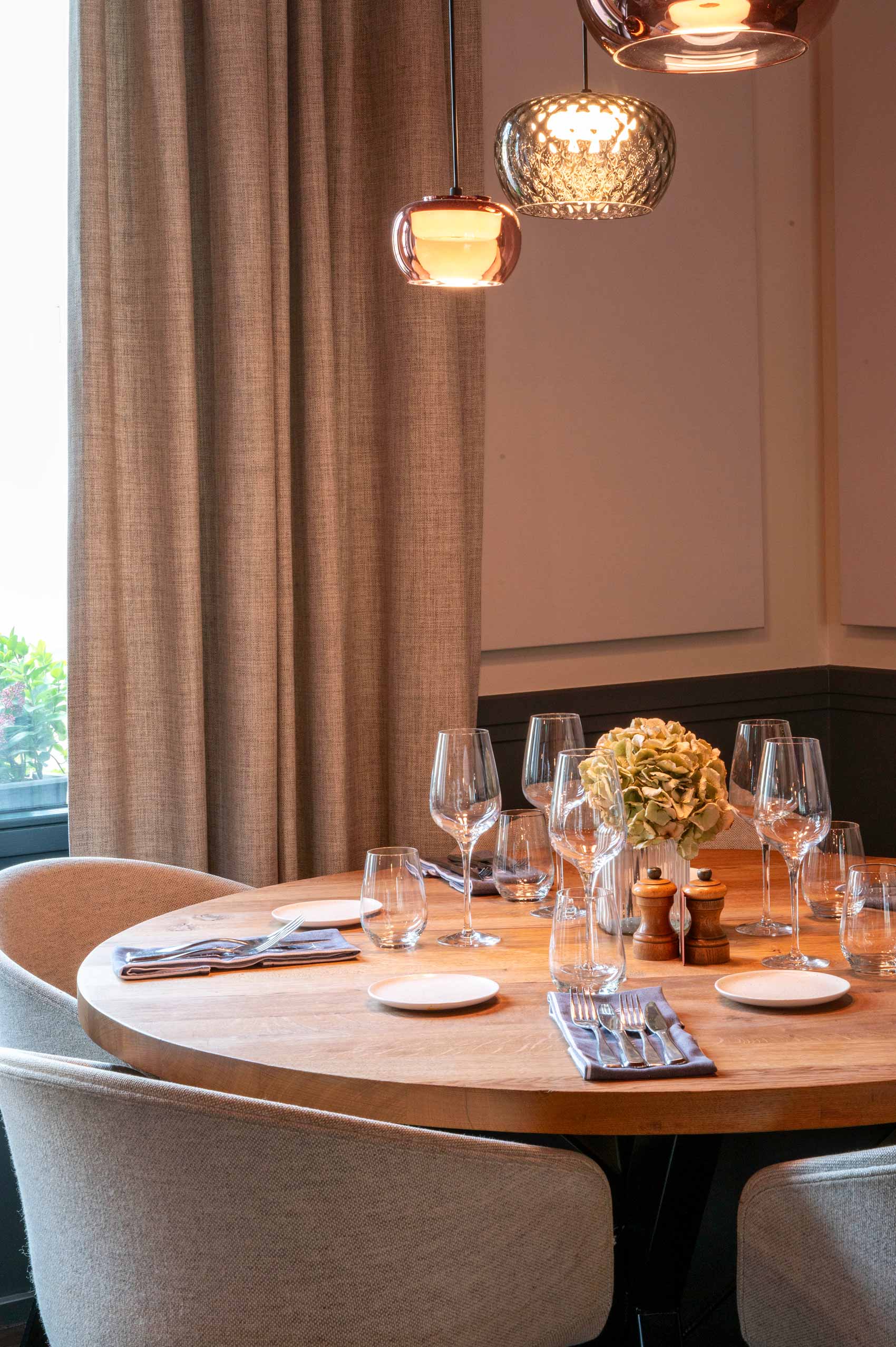Elegant dining table with glasses and centerpieces.