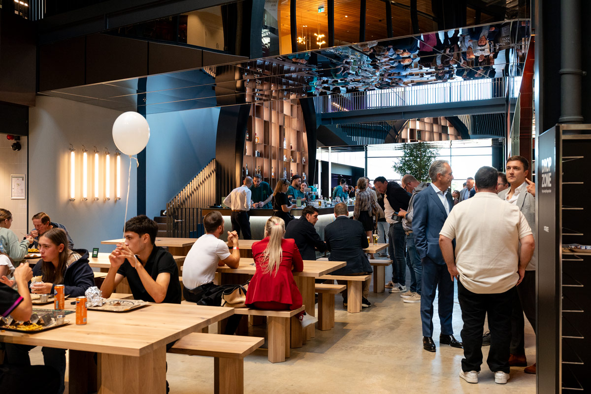 People socializing in a modern cafe setting.