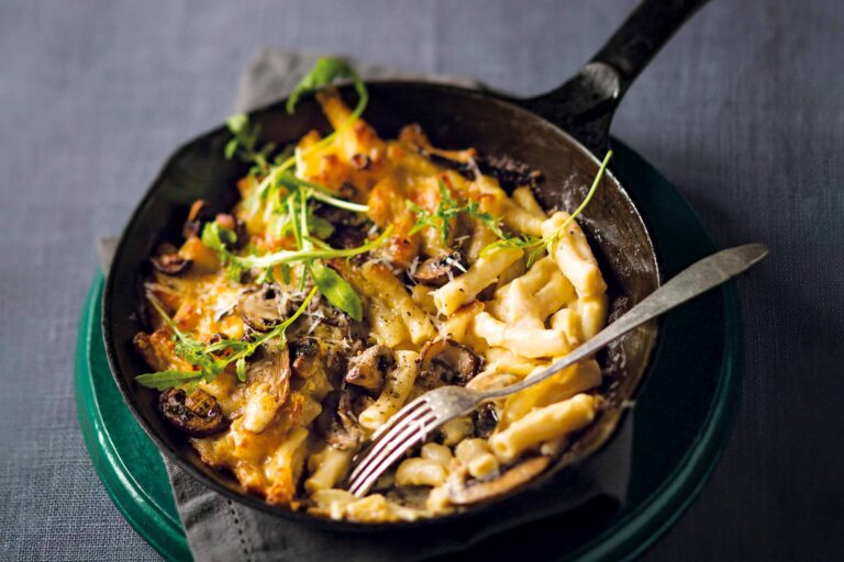 Creamy baked pasta with mushrooms in skillet