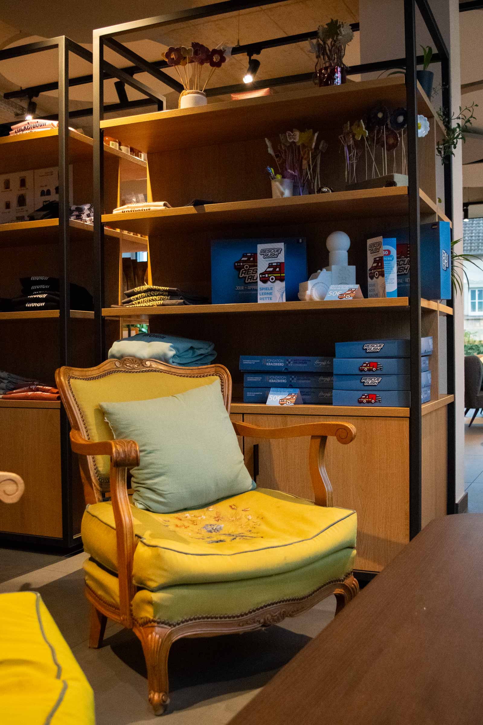 Cozy chair next to wooden shelves in a store.