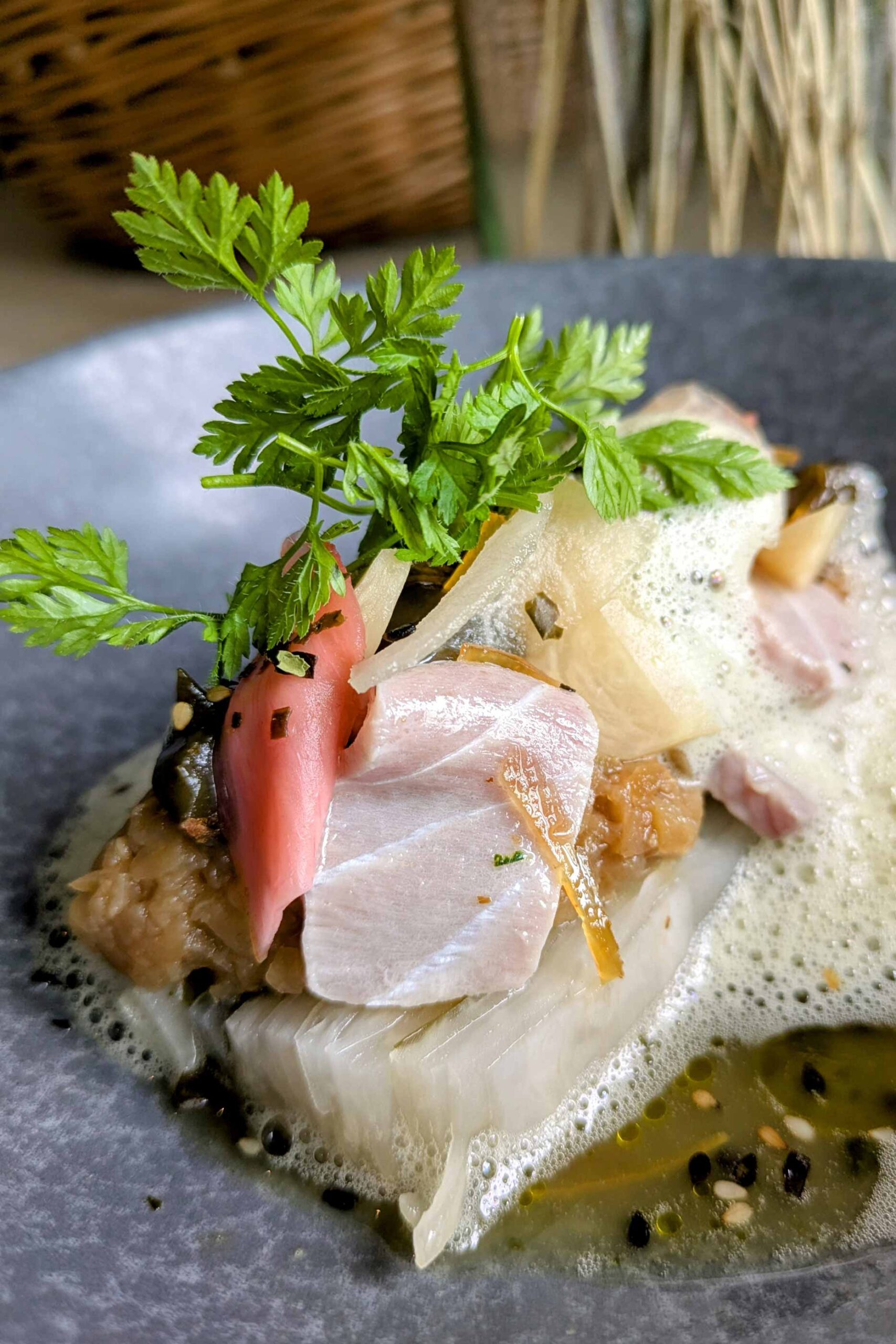 Plated gourmet dish with herbs and sauce.