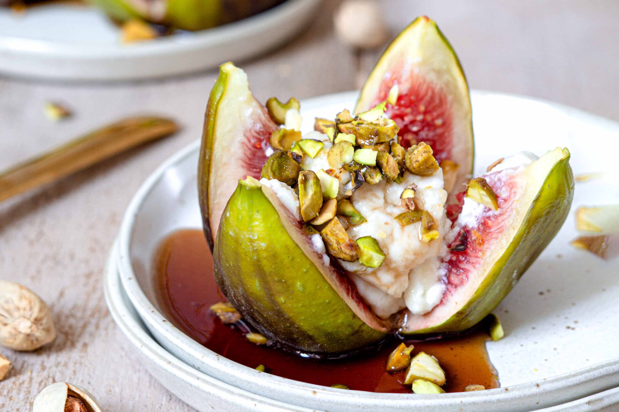 Stuffed figs with cream and pistachios on plate