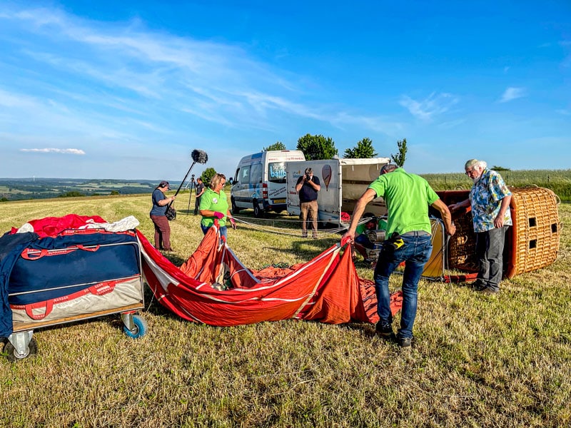Preparing hot air balloon for launch in field