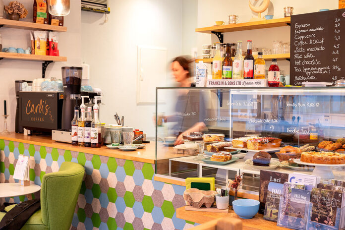 Cozy cafe interior with coffee and pastries display.