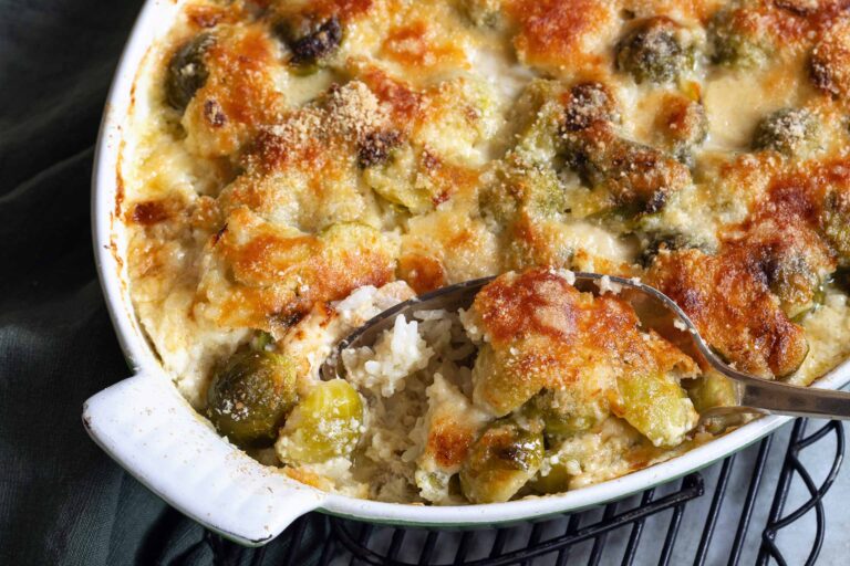 Baked Brussels sprouts casserole with cheesy topping.