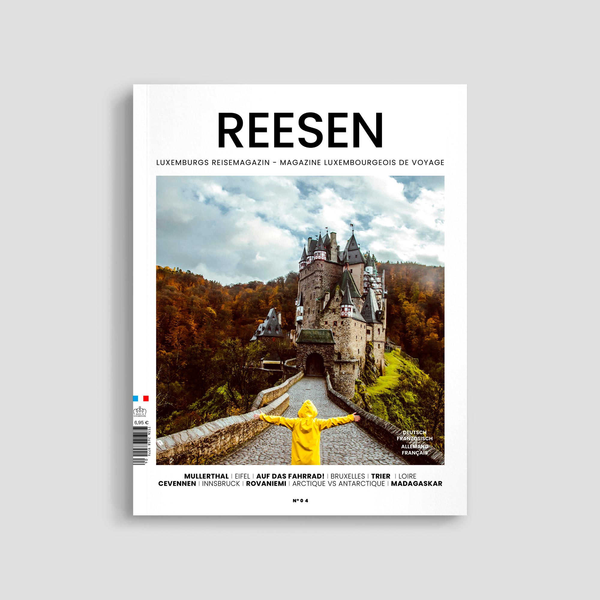 Traveler in yellow coat at medieval castle entrance.