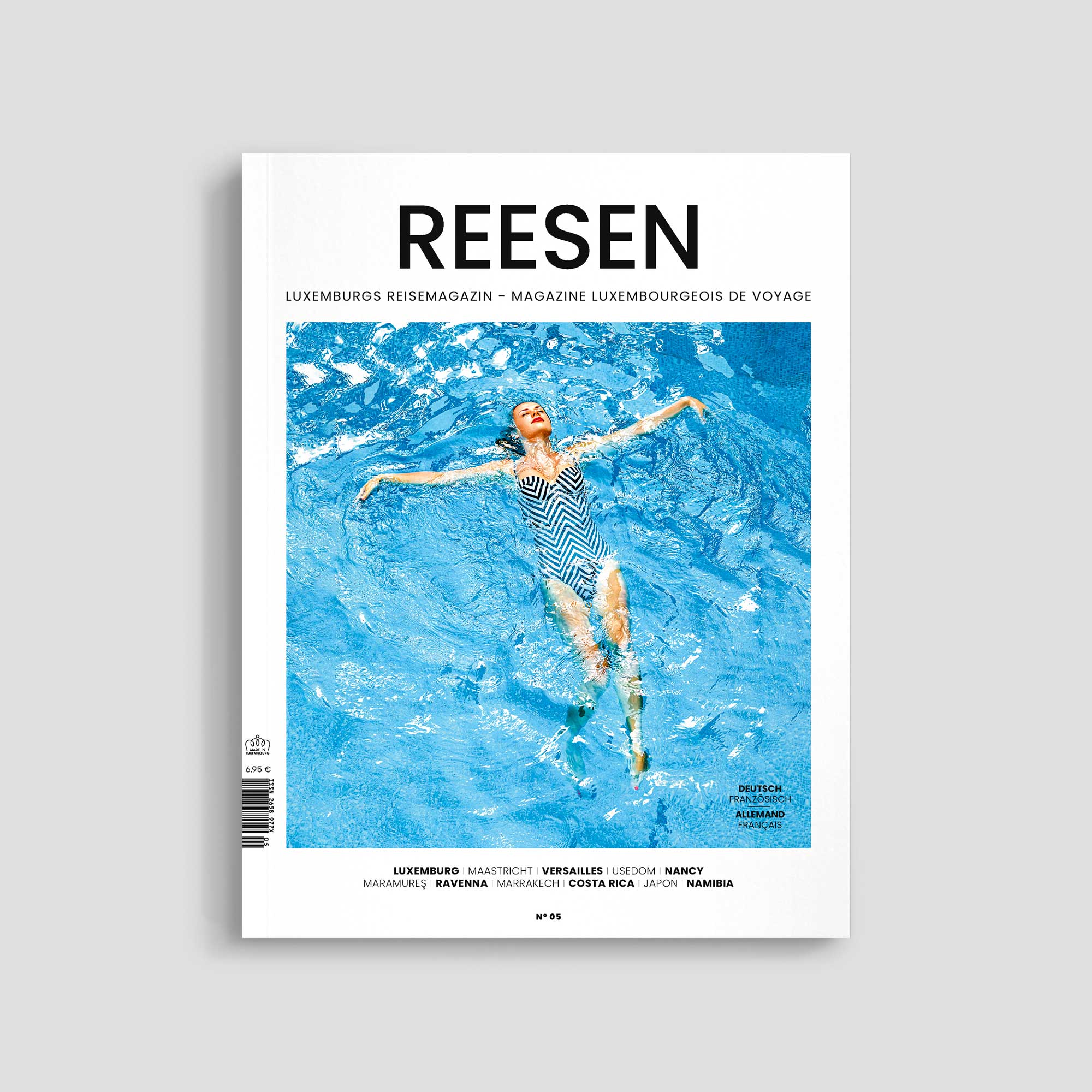 Magazine cover featuring woman swimming in pool.