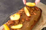 Placing apple slices on caramel pecan loaf cake